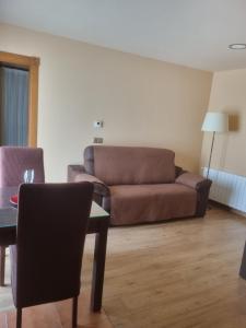 a living room with a couch and a table at Apartamentos Villa Sofía in San Vicente de la Barquera