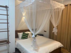 Postel nebo postele na pokoji v ubytování Ella Leafy Homestay