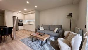 a living room with a couch and a table at BPirineos-Llardana in Benasque