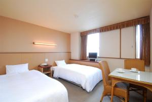 Postel nebo postele na pokoji v ubytování Sunsky Hotel