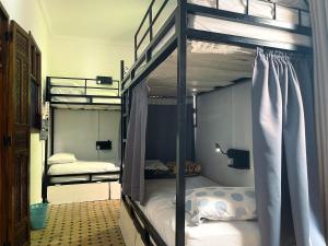A bed or beds in a room at Tangier Kasbah Hostel