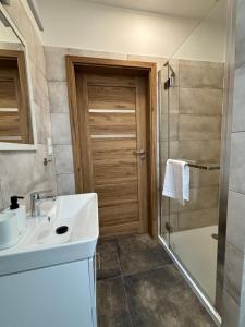 a bathroom with a sink and a shower at Janowa Góra 9A in Sienna +59 photos