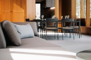 a couch with a pillow on it in a room at JADE D Plus and E Plus Hakuba in Hakuba