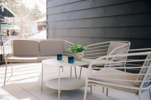 a patio with chairs and a table and a couch at JADE D Plus and E Plus Hakuba in Hakuba