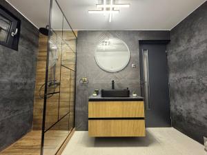 a bathroom with a sink and a glass shower at Cabana A Frame In Jomp in Gârda de Sus +14 photos