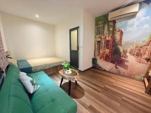 a living room with a green couch and a bedroom at SOHO 1 PHÚ QUỐC in Phu Quoc +118 photos