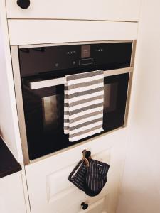 a kitchen with a black oven with white towels at Cottage with Hot Tub - near Cheltenham and Tewkesbury in Cheltenham