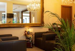 a waiting room with a mirror and a couch at La Castellana Loft Hotel in Bergamo