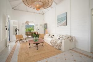 un soggiorno con un divano e un tavolo di Villa M'Bay a Sainte-Marie Altre 36 foto