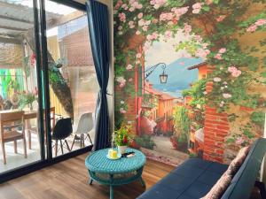 a living room with a wall mural of a street at SOHO 1 PHÚ QUỐC in Phú Quốc