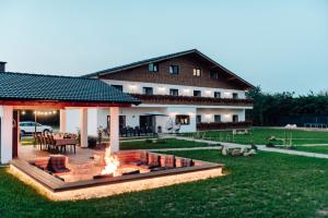 a house with a fire pit in the yard at Casa Hirsch in Avrig