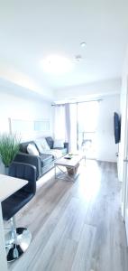 a living room with a couch and a table at 1 Bedroom condo with balcony Erb St Waterloo in Waterloo