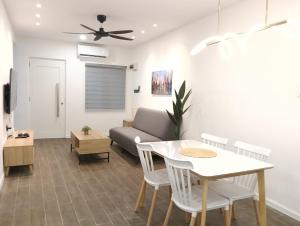 a living room with a table and a couch at H62 Muar Home in Muar