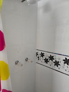 a bathroom with a shower with black spiders on it at Alojamiento en Puno in Puno +34 photos