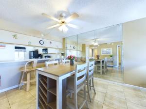 a dining room and kitchen with a table and chairs at Sandcastles 2br2ba Cocoa Beach Ocean Views! in Cocoa Beach