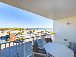 a balcony with a table and chairs and a view of the beach at Sandcastles 2br2ba Cocoa Beach Ocean Views! in Cocoa Beach