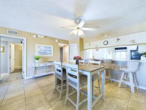 a kitchen and dining room with a table and chairs at Sandcastles 2br2ba Cocoa Beach Ocean Views! in Cocoa Beach