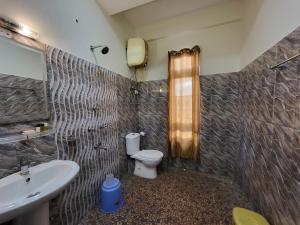 a bathroom with a toilet and a sink at The Star Continental & Spa Gangtok in Gangtok +46 photos