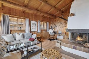 a living room with a couch and a fireplace at Maiensäss Stafel 45 in Mutten