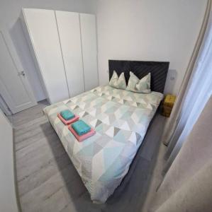 a bedroom with a bed with two pillows on it at myHome Residence in Nazna