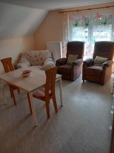 a living room with a couch and a table and chairs at Haus Hopfgarten in Schwalmtal