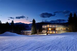 a large building in the snow at night at Suite 1400 in Marilleva