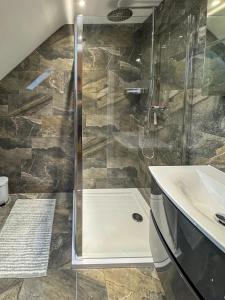 a bathroom with a shower and a sink at Lux House, Jennett's Park in Bracknell