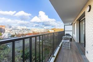 a balcony with a view of the city at L'Escapade Paris in Le Kremlin-Bicêtre