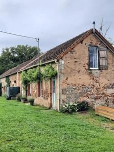 an old brick building with a window and green grass at Gîte 'La BelleVue' in Feusines +23 photos