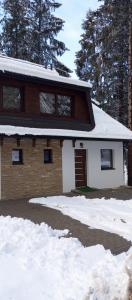 a house with snow in front of it at Ruža Vetrova 4 in Nova Varoš