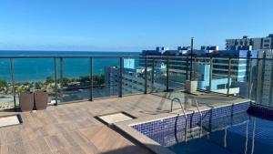 a balcony of a building with a view of the ocean at Gales de Pajuçara 703 Conforto, Piscina na Cobertura, Wifi 350 Mbps e a 50m da Praia! in Maceió