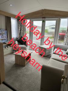 a living room filled with furniture and a large window at Holiday escapes by the bay in Heysham
