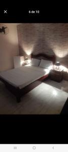 a bedroom with a bed with lights on it at Suítes in Fonseca