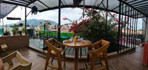 a table and chairs in a room with a view at Hotel Boutique Casa Mariano in Tepic