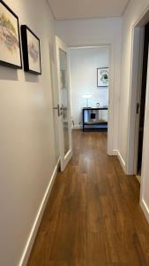 a room with a hallway with a hard wood floor at River View apartment in Chaves