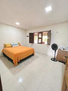 a bedroom with a bed in a white room at Sítio Caju in Aquiraz