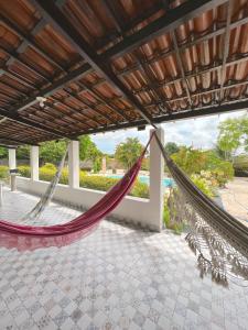 a hammock on the patio of a house at Sítio Caju in Aquiraz