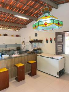 a kitchen with a counter and a stained glass window at Sítio Caju in Aquiraz