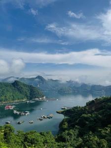 a view of a river with boats in the water at Nắng Village in Hòa Bình