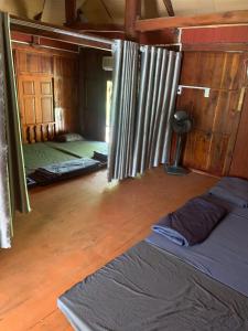 a room with two beds and curtains in it at Nắng Village in Hòa Bình
