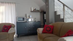 a living room with two chairs and a microwave at Somerset-West, Heldervue in Cape Town