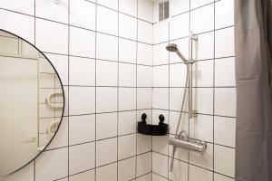 a bathroom with a shower with a mirror at Visaginas Flat White in Visaginas