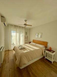 a bedroom with a large bed and a window at Apartamento Benicàssim Sunset Calm&Views in Benicàssim +10 photos