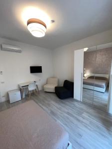 a bedroom with a bed and a couch and a table at Casa vacanza Natasha in Como