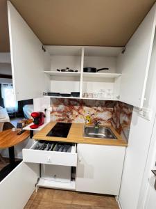 a kitchen with white cabinets and a sink at Modern Studio N9 Kitchenette Bathroom in Limassol +10 photos