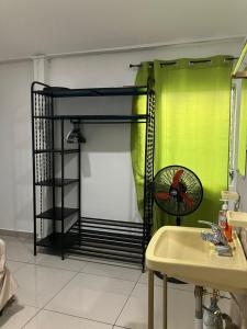 a black bunk bed in a bathroom with a fan at Hostal El Amate #1 in Suchitoto
