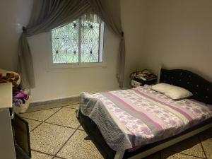 a bedroom with a bed and a window at Achraf Immo in Fez