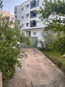 an empty sidewalk in front of a building at Achraf Immo in Fez