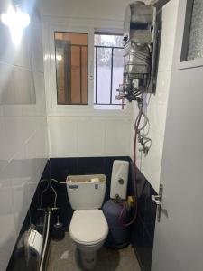 a small bathroom with a toilet and a window at Achraf Immo in Fez