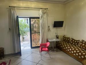 a living room with a couch and a table and a door at Achraf Immo in Fez